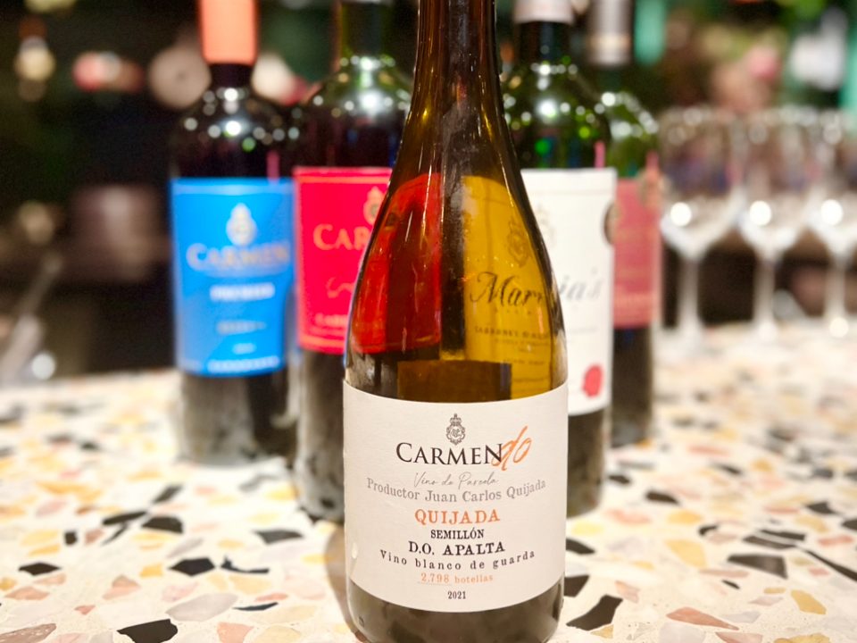A triangle of wine bottles with a Vina Carmen Semillon at the forefront.
